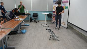 Prof. Yubei Chen came to the workshop riding a robot dog. He presented on how AI is revolutionizing every field.  
